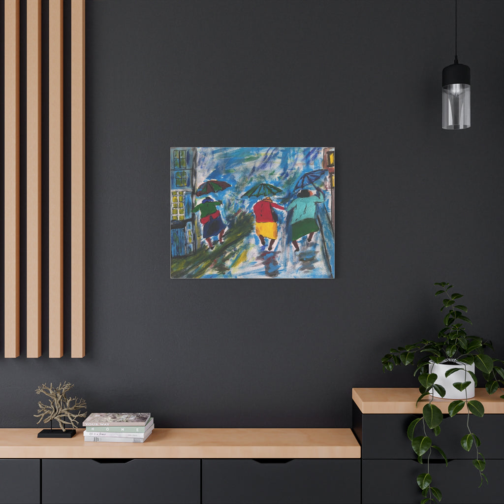 Framed artwork of people with umbrellas on a dark wall above a wooden console table.
