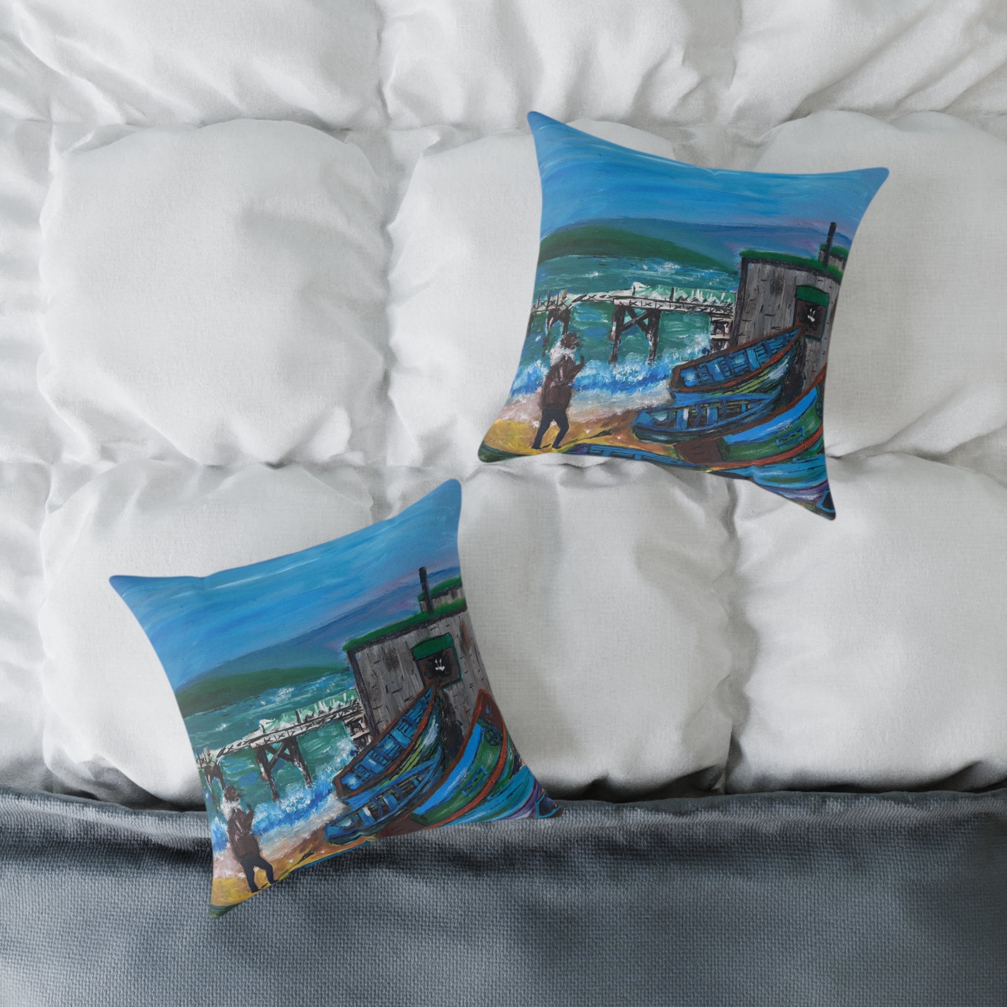 two cushions showing isle of wight coastal scene on a bed