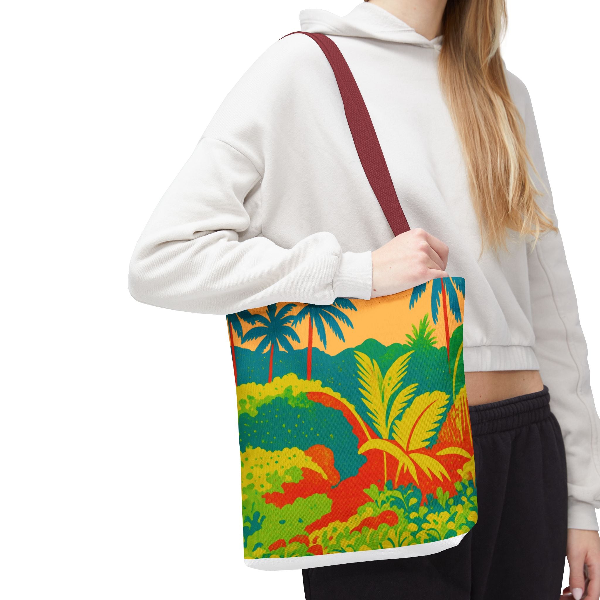 Person wearing a white hoodie with a colorful tropical patterned bag inspired by St Joseph in Barbados.