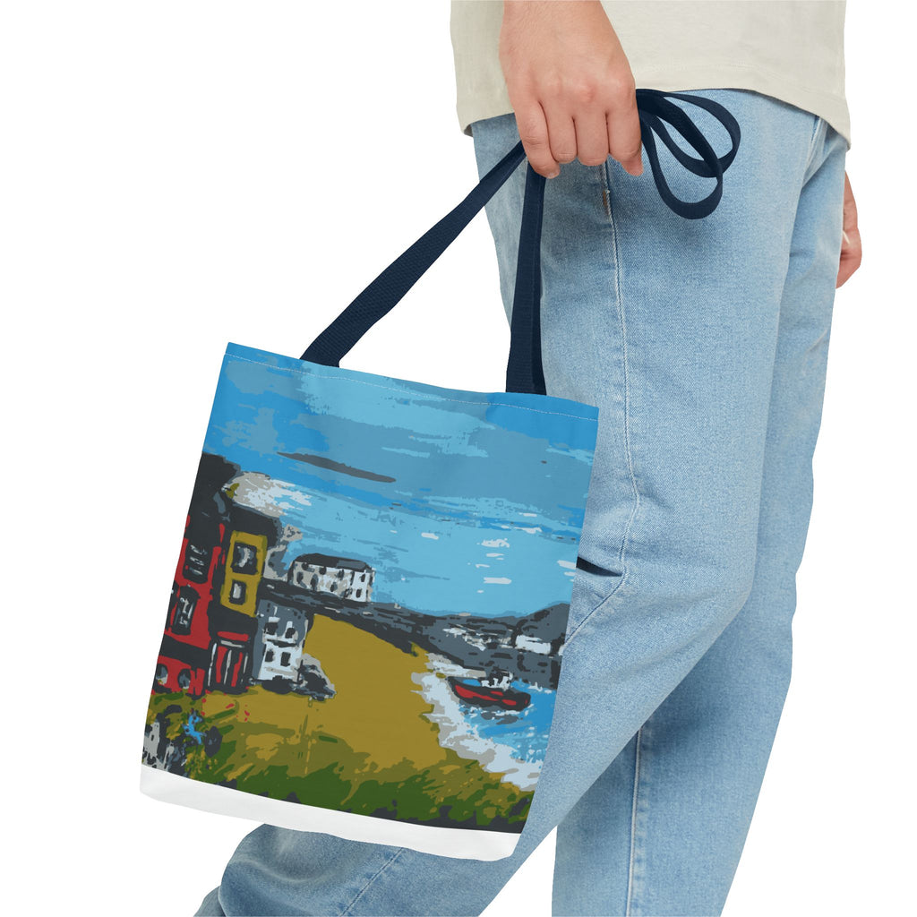 Tote bag held by the side of a man's legs with a scenic design of  Viking Bay in Broadstairs, Kent showing houses and boats on a white background