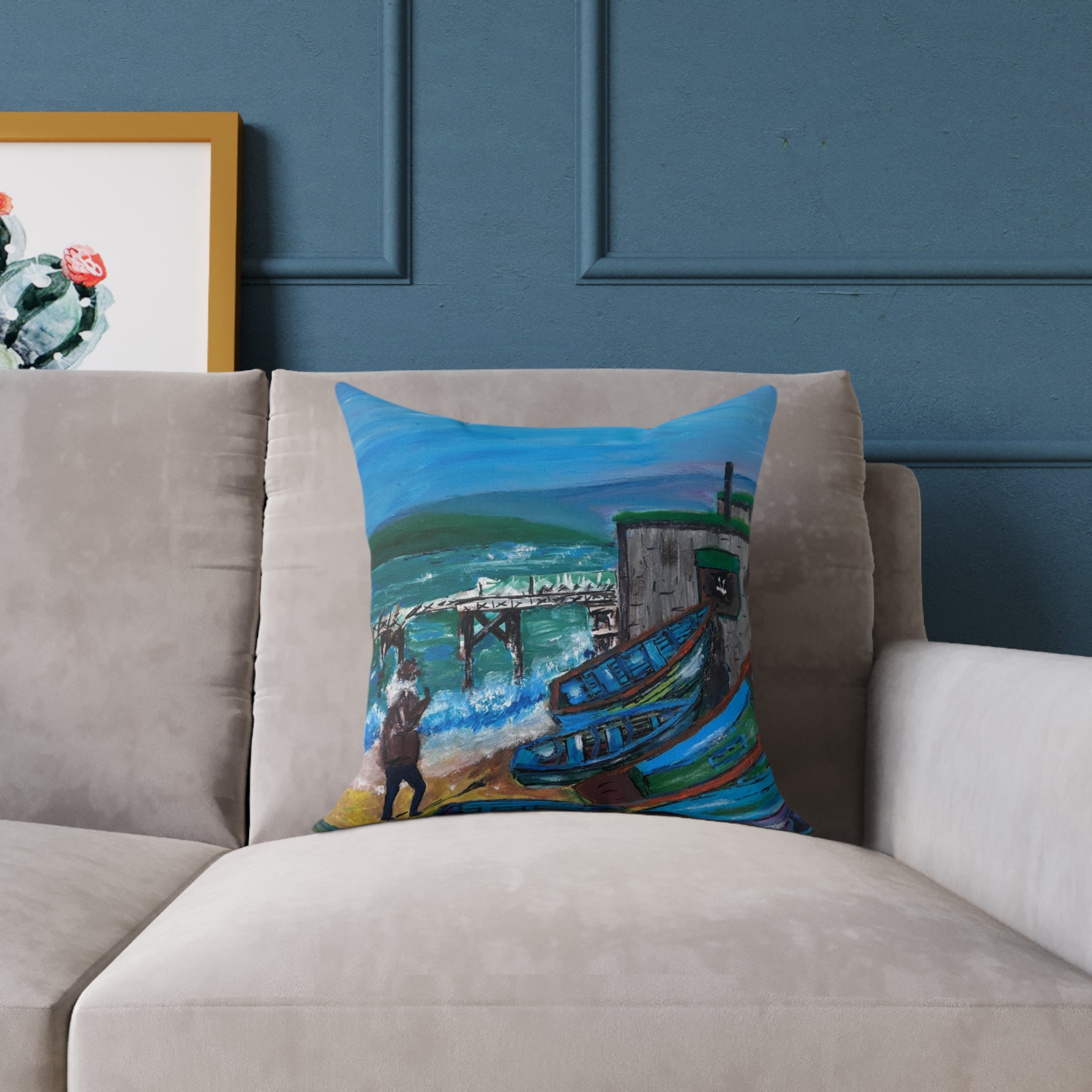 coastal scene of isle of wight on a cushion on a beige sofa on a blue background 