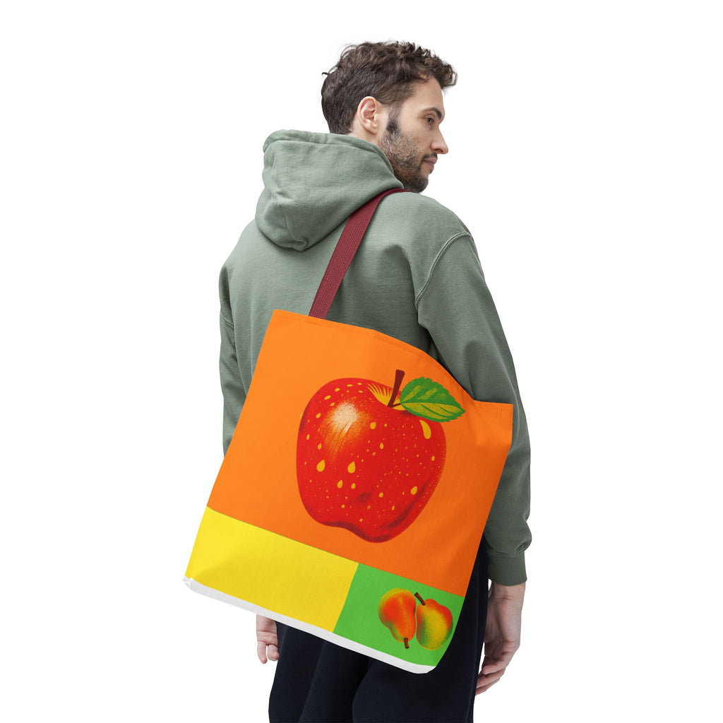 Person wearing a green hoodie with a colorful tote bag featuring an apple design on a white background