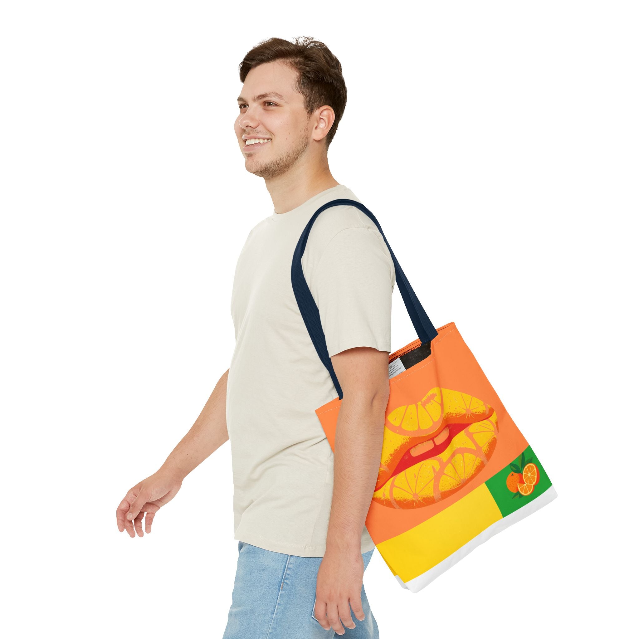 Man carrying a colorful tote bag with a citrus lips design on a white background