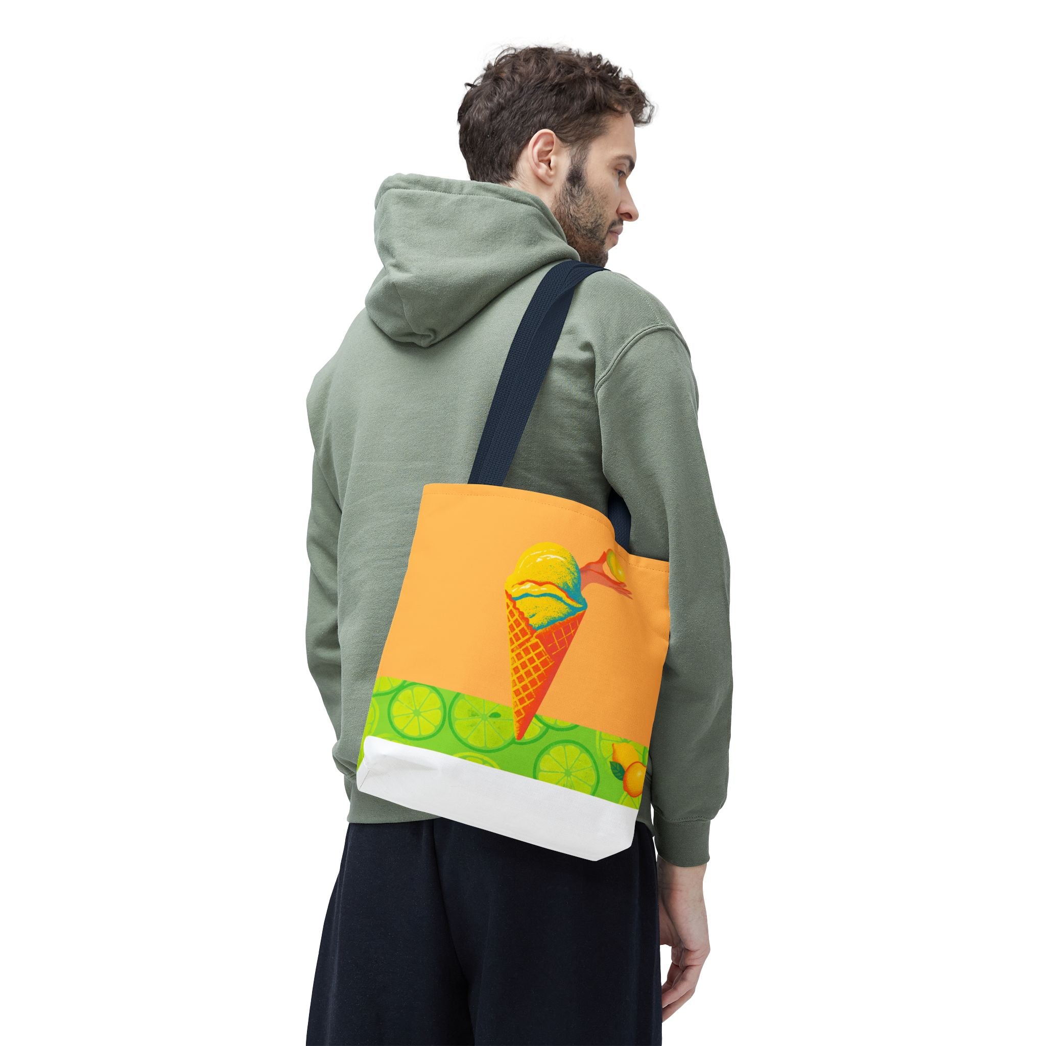 tote bag with lemon ice cream design carried by a man in a green hoodie