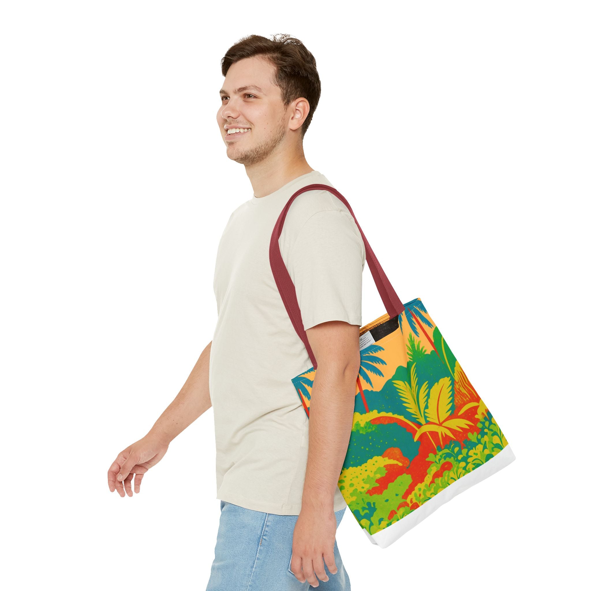 Man carrying a colorful tote bag with a leaf pattern inspired by St Joseph in Barbados on a white background