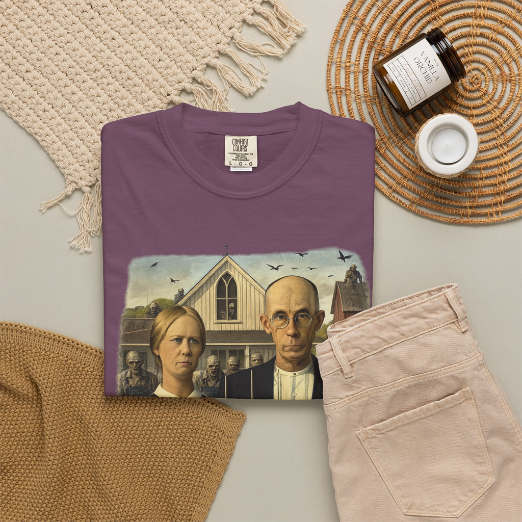 Folded burgundy t-shirt with reimagined image of zombies in American Gothic by Grant Wood on a white background