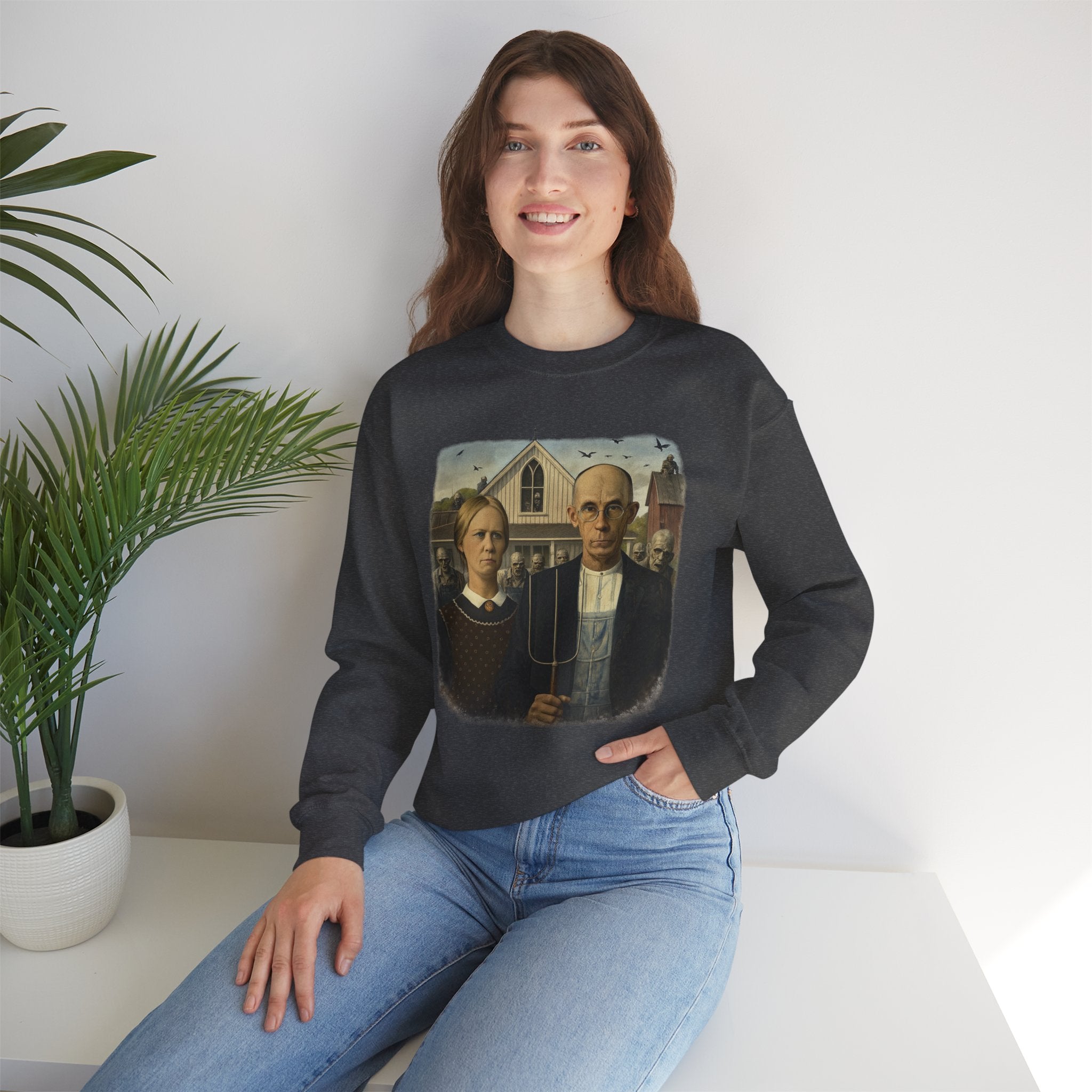 woman wearing black sweatshirt with a reimagined image of American Gothic by Grant Wood on a white background