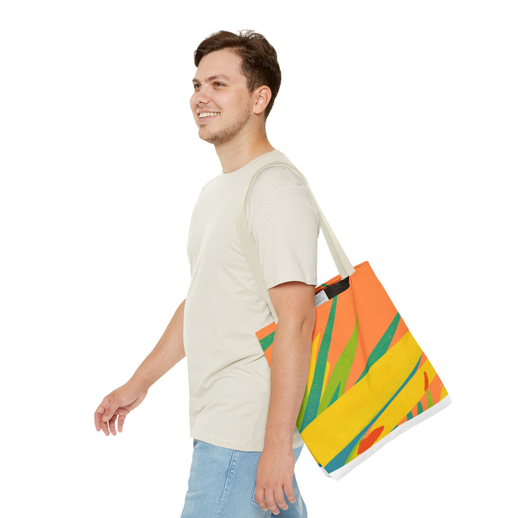 Man carrying a colorful tote bag with tropical design inspired by Ragged Point, St Philip, Barbados on a white background