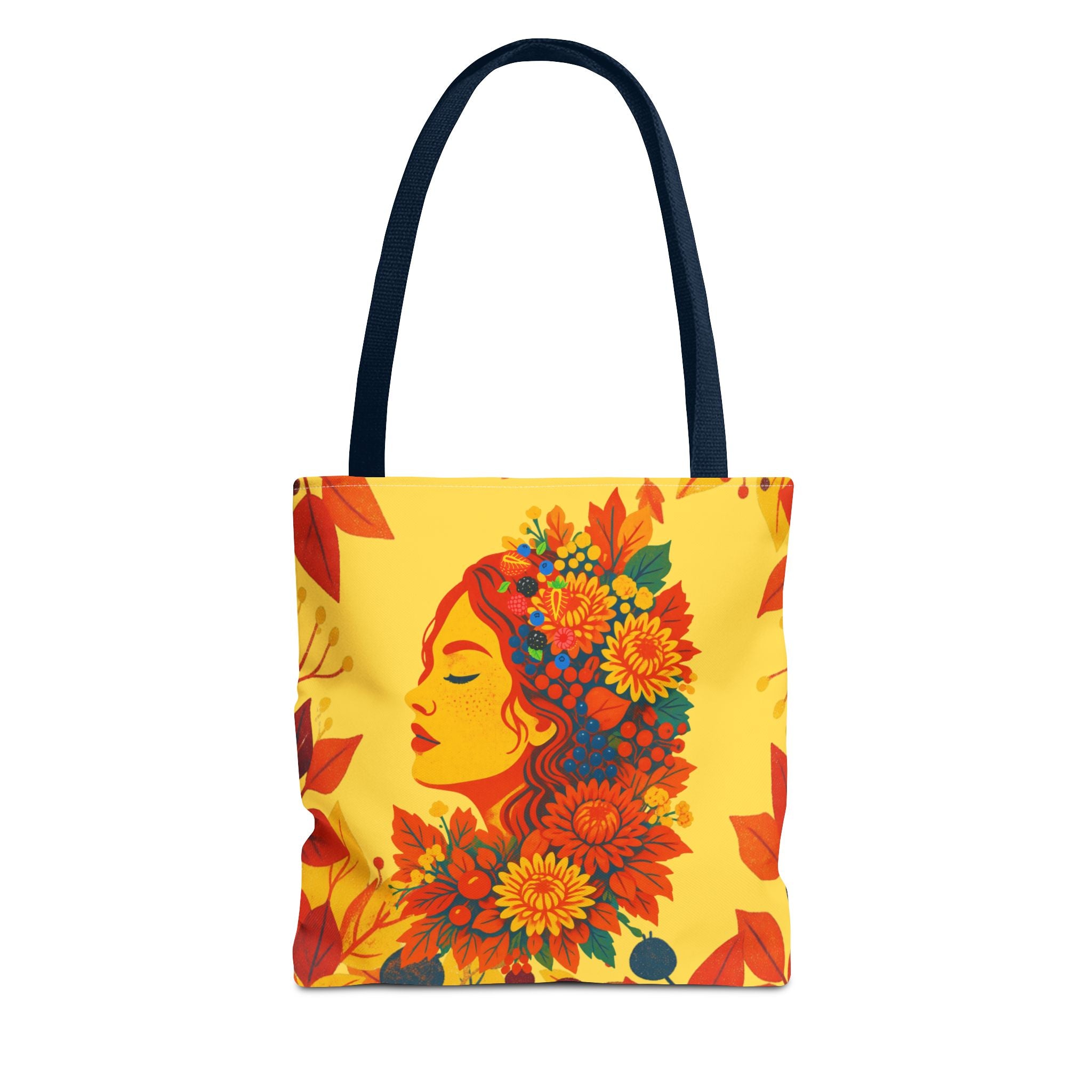 Tote bag with a colorful design of a woman's face surrounded by flowers on a yellow background.