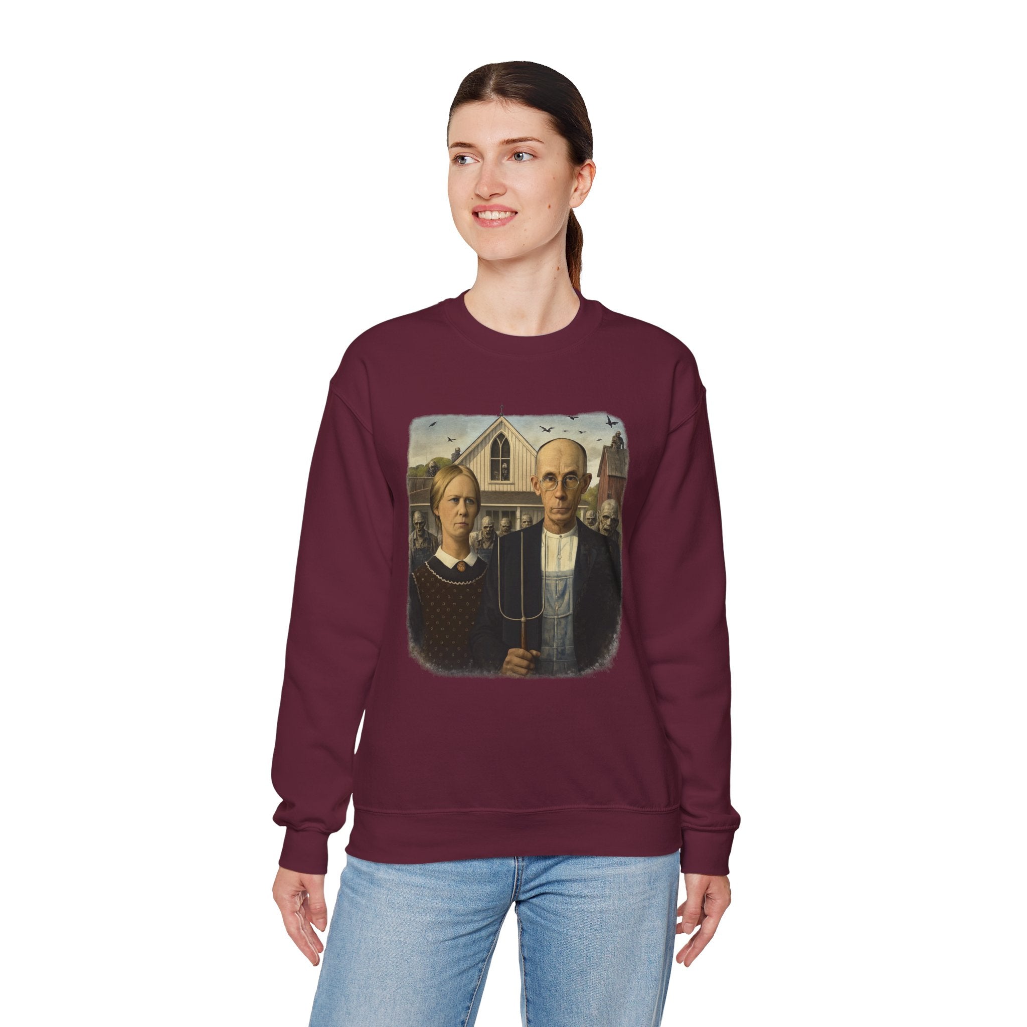woman wearing maroon sweatshirt with a reimagined image of American Gothic by Grant Wood on a white background