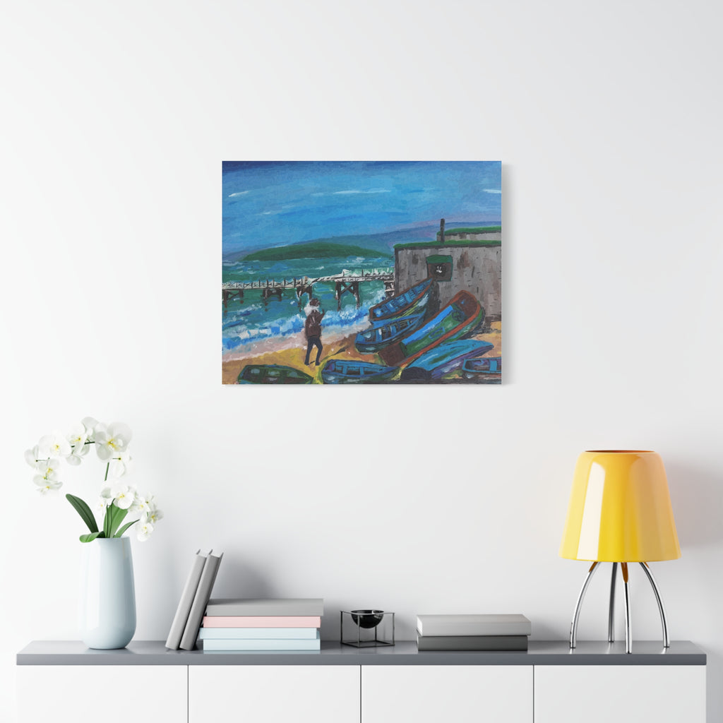 Painting of a coastal scene with boats on a wall above a shelf with decorative items.