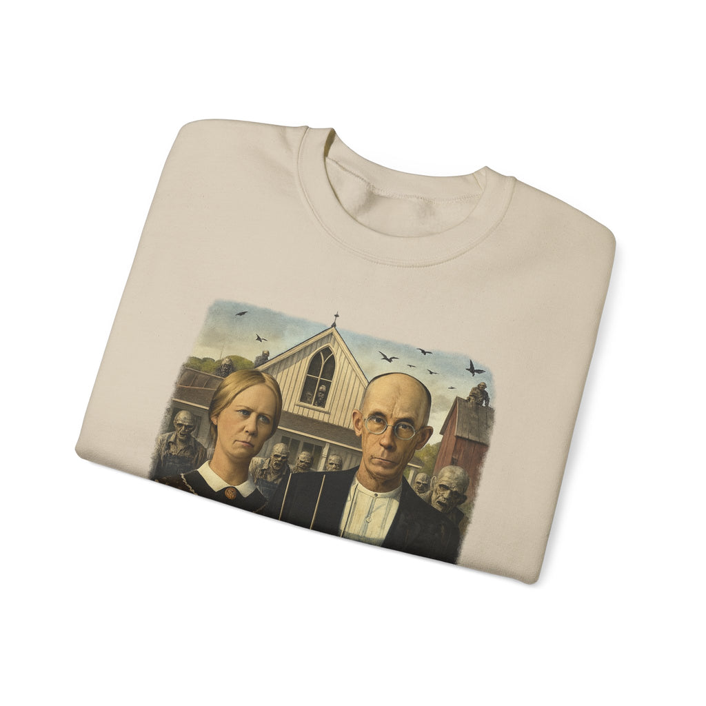 folded sand colour sweatshirt with a reimagined image of American Gothic by Grant Wood on a white background