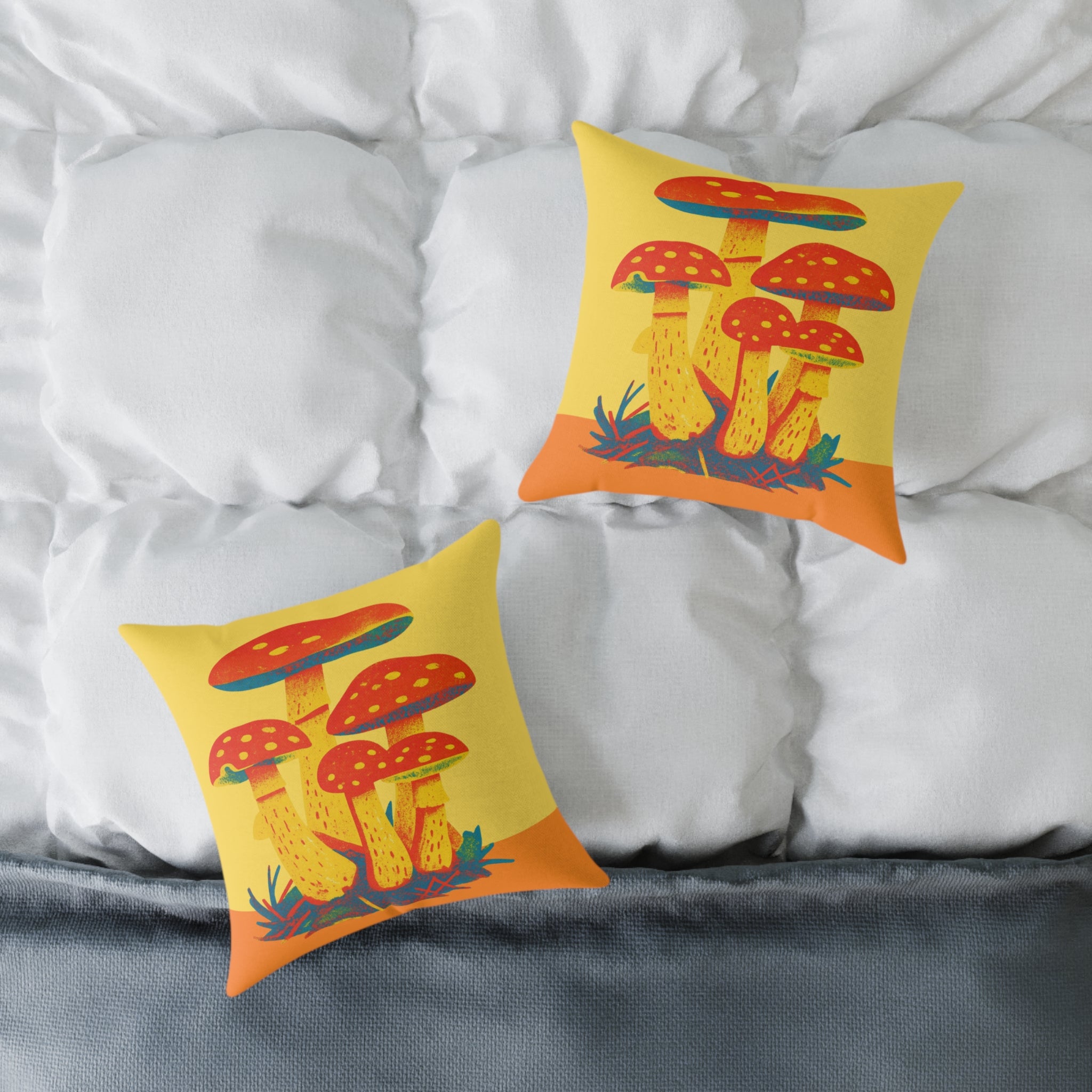 Two pillows with colourful mushroom design on a bed