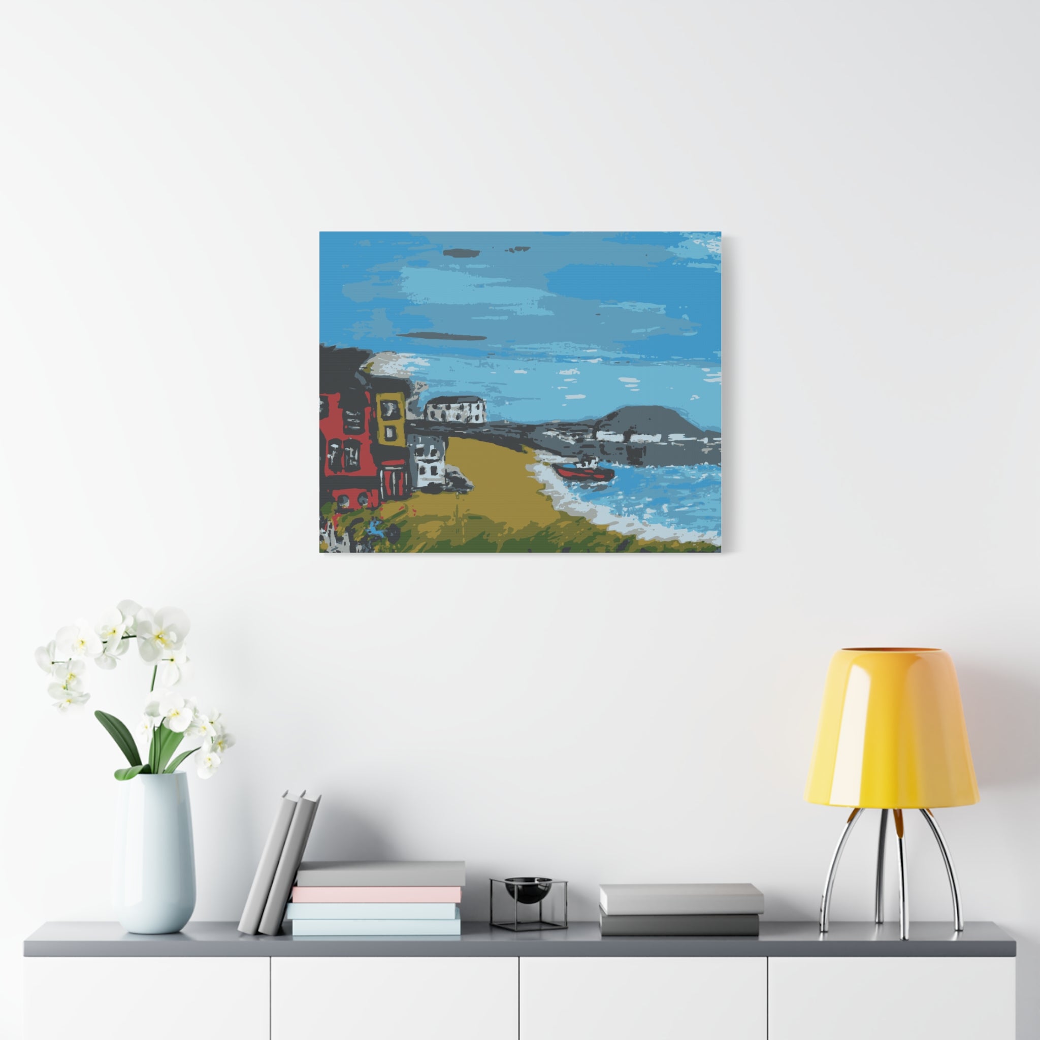 Painting of a coastal scene with houses and a boat on a white wall above a shelf with decor items.
