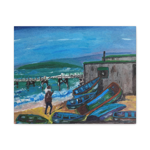 Painting of a person standing near overturned boats on a beach with a pier and mountains in the background.