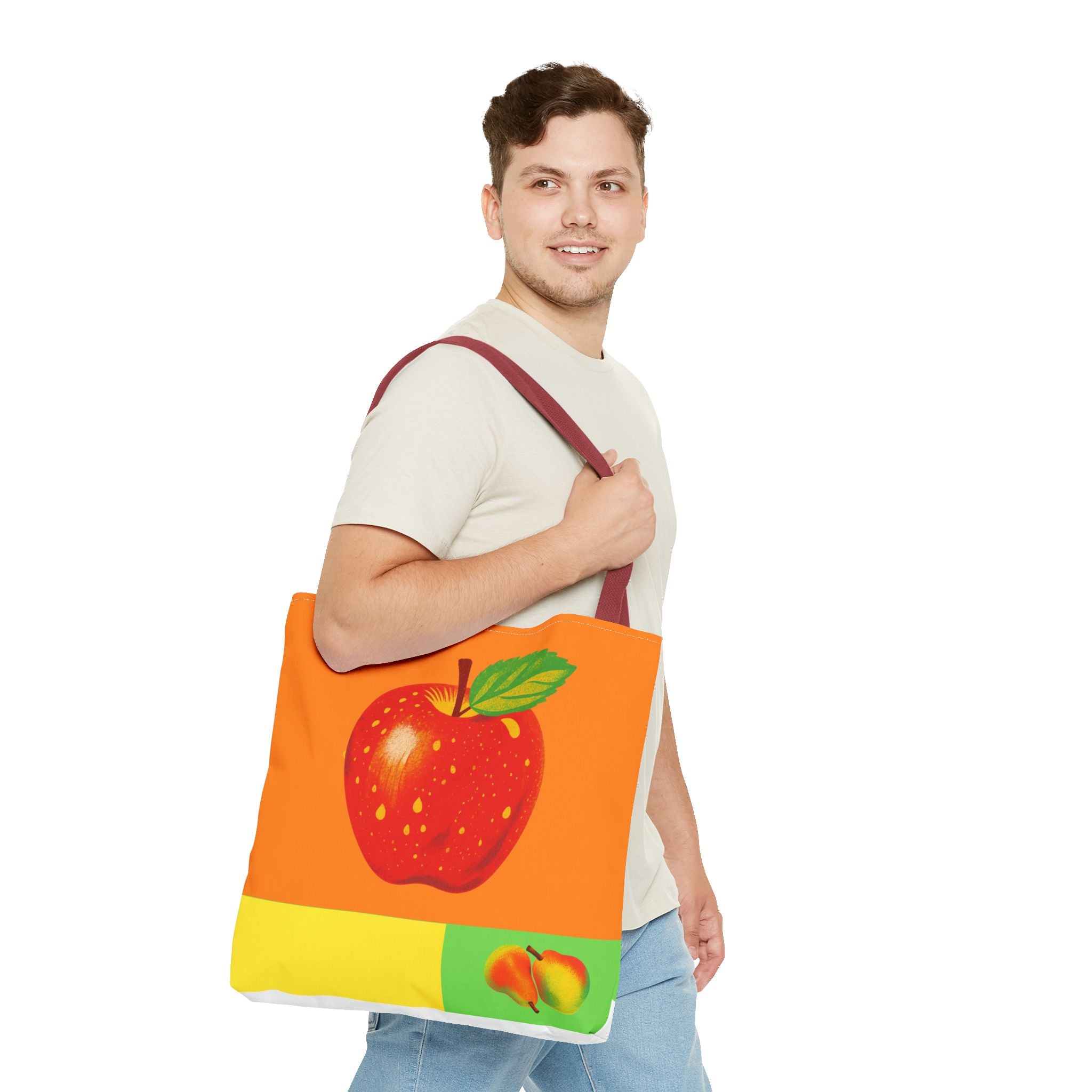 Man holding a tote bag with an apple design on a white background