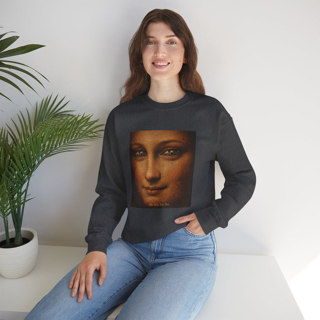 woman sitting on a seat wearing a black sweatshirt showing a reimagined image of Da Vinci's Mona Lisa on a white background