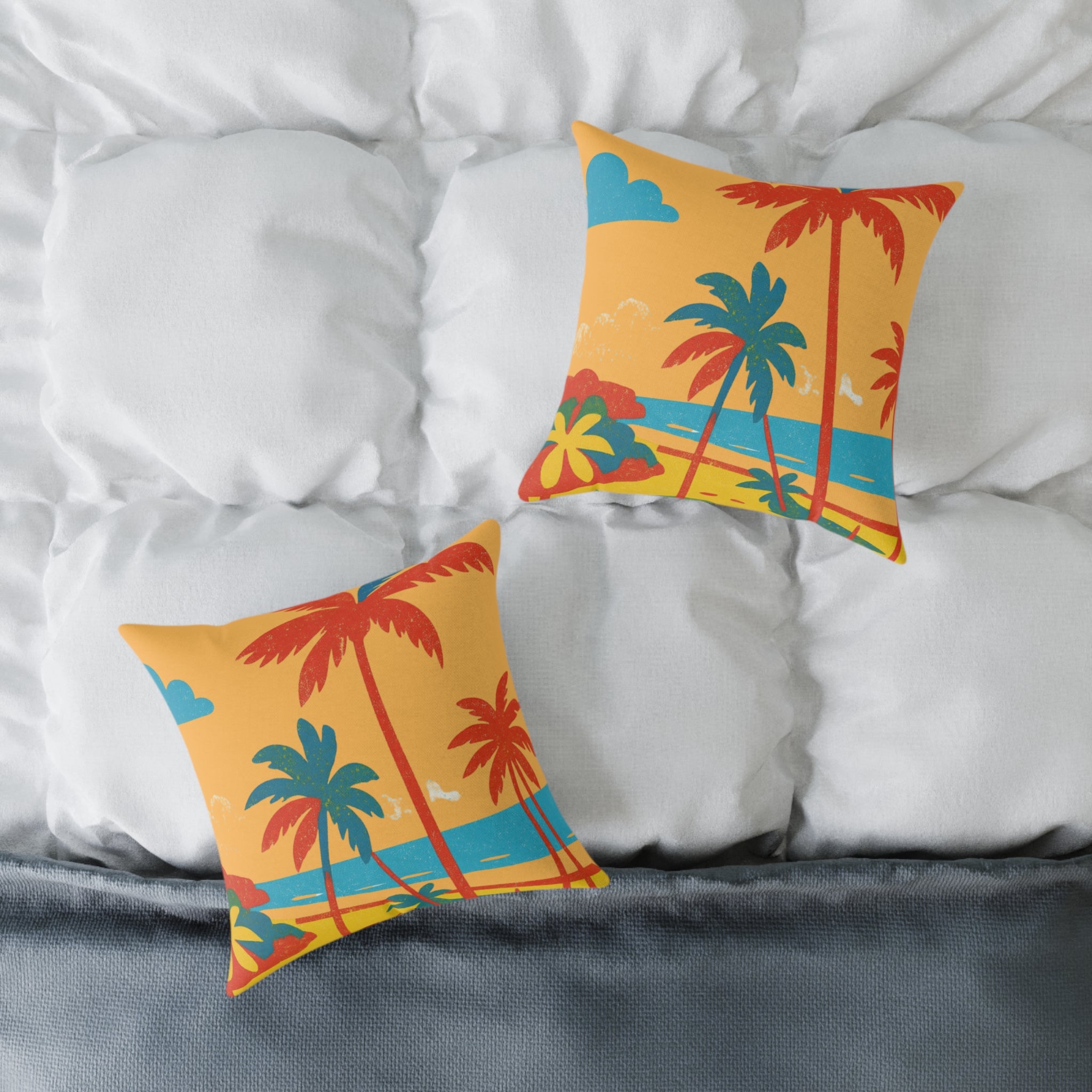 Two decorative pillows with palm tree design on a bed