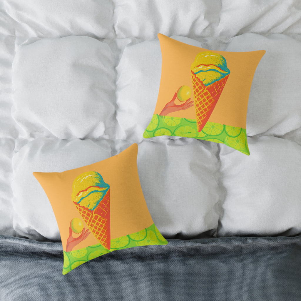 Two decorative pillows with a colorful design on a bed with white pillows and gray bedding.