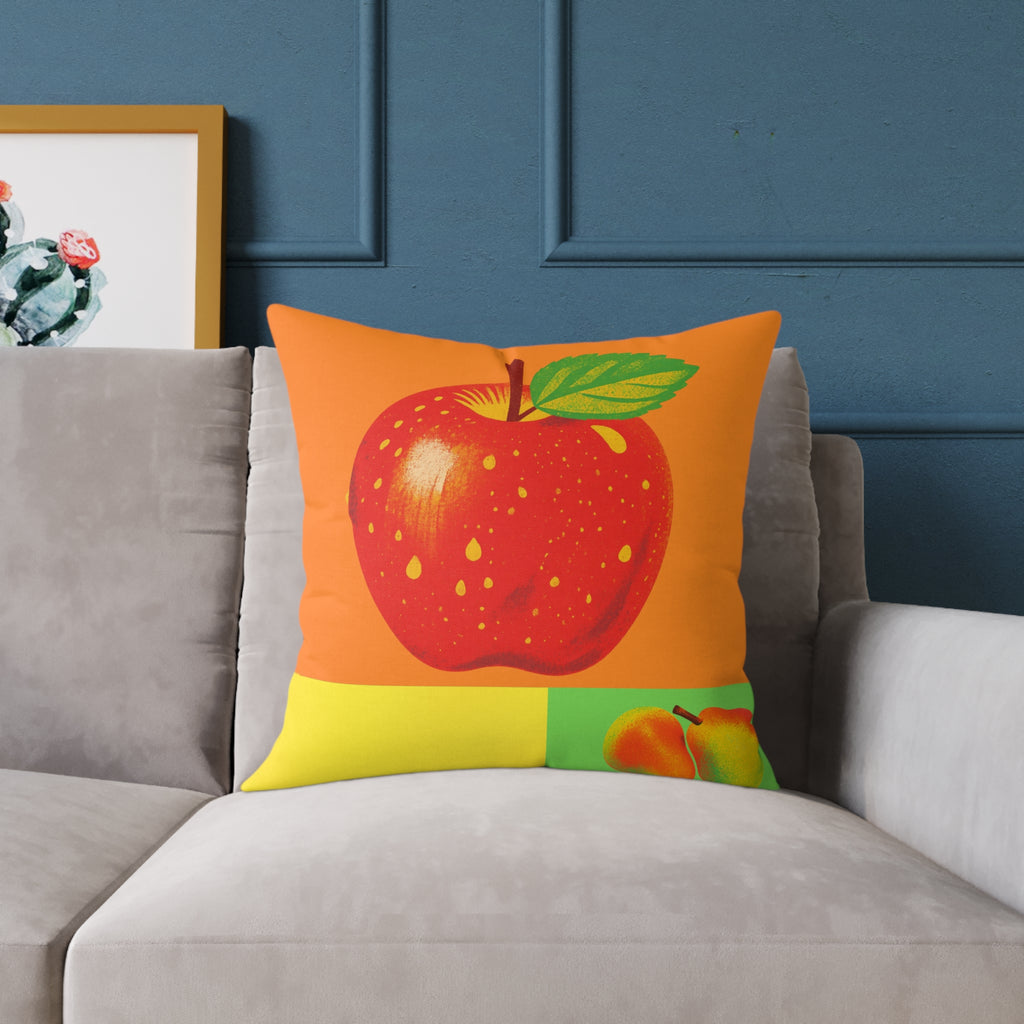Decorative pillow with a red apple design on a gray sofa against a blue wall.