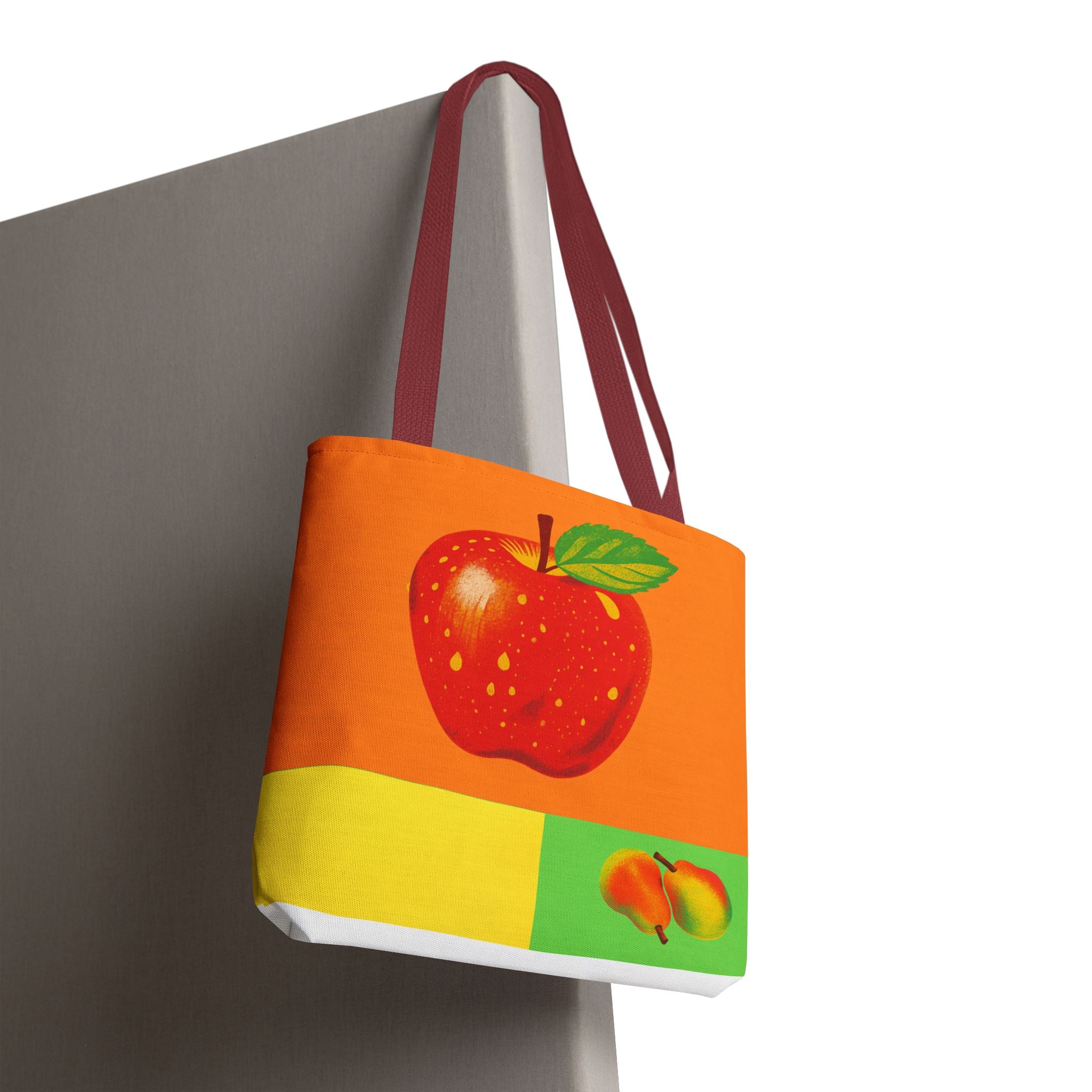Colorful tote bag with an apple design on a white background