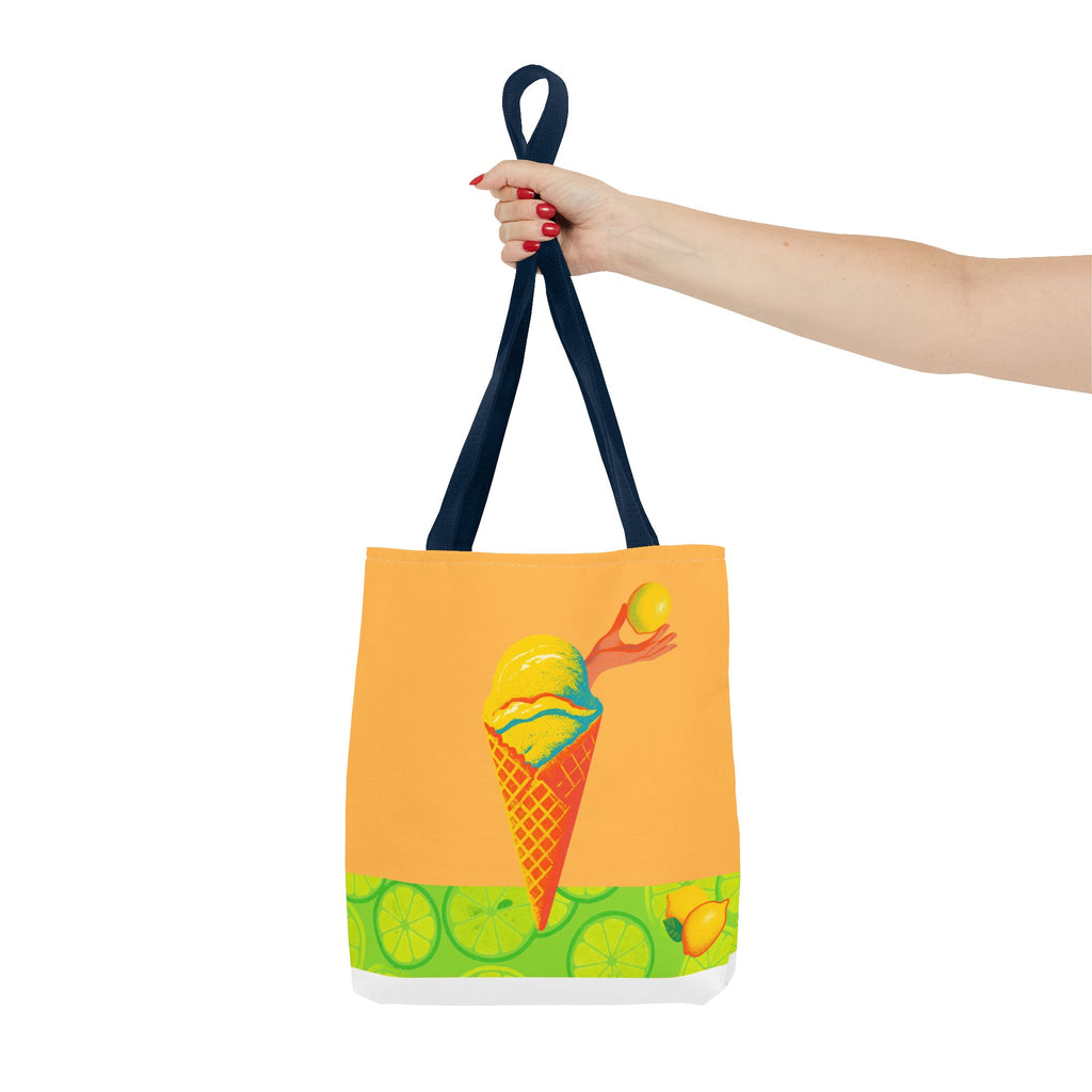 Tote bag with ice cream cone design held by a hand on a white background