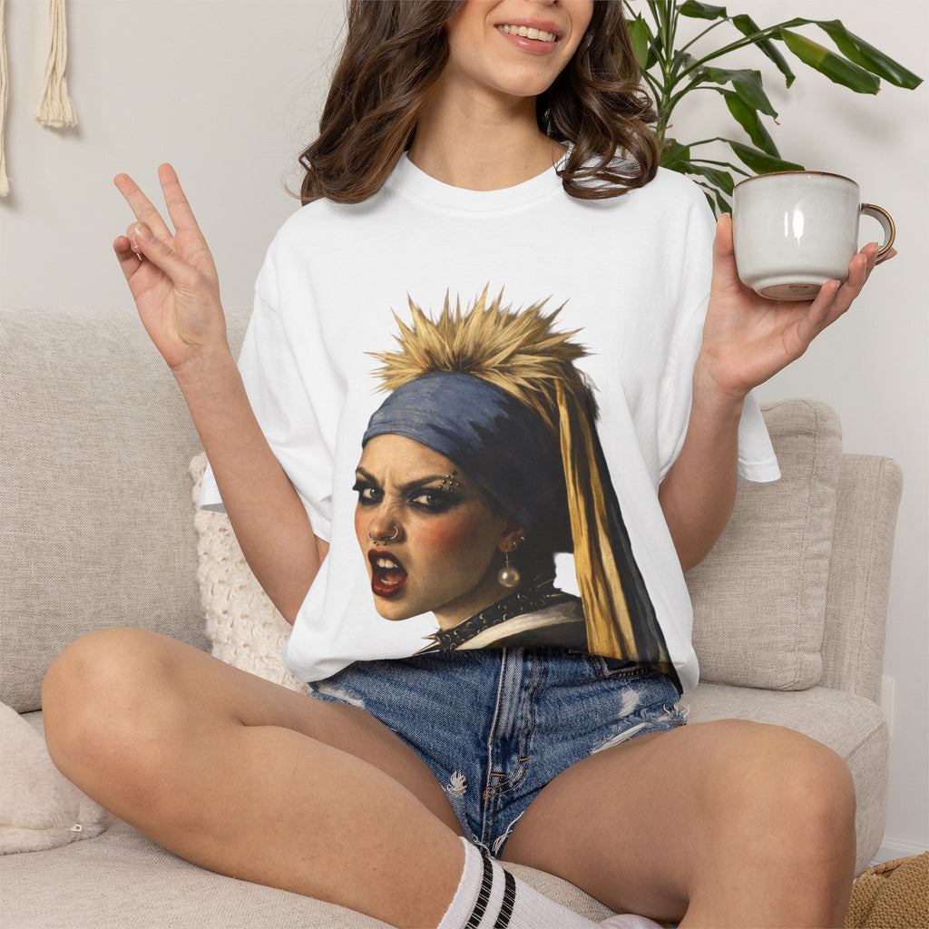 Person wearing a white t-shirt with a reimagined image of Vermeer's girl with a pearl earring sitting on a stool against a white background