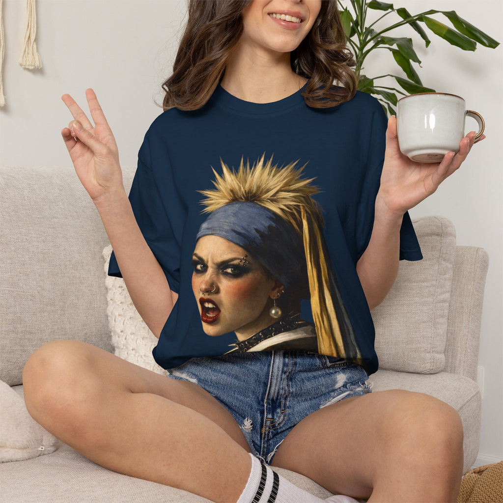 Person wearing a navy t-shirt with a reimagined image of Vermeer's girl with a pearl earring sitting on a stool against a white background