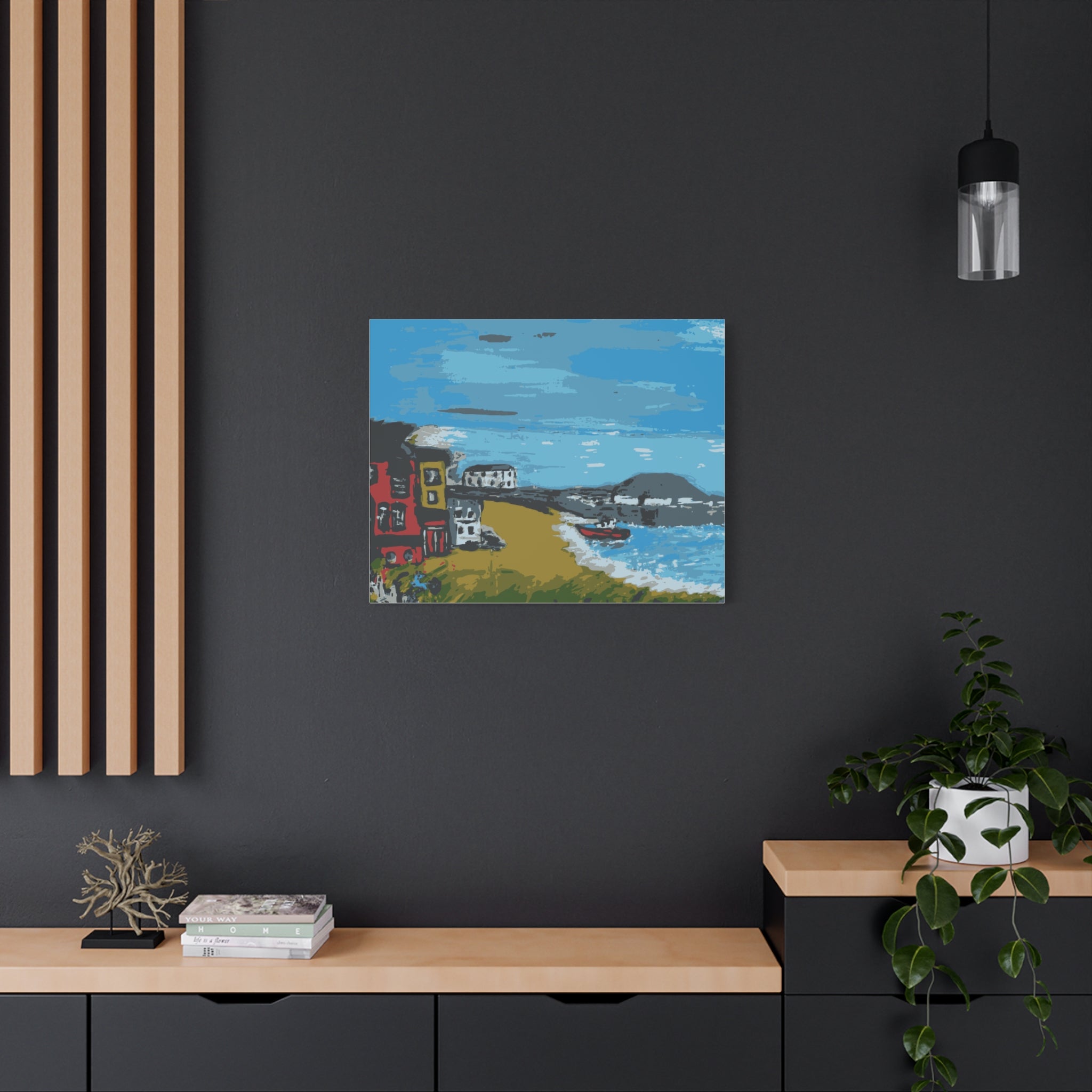 Framed artwork of a coastal scene on a dark wall with wooden shelves and decor.