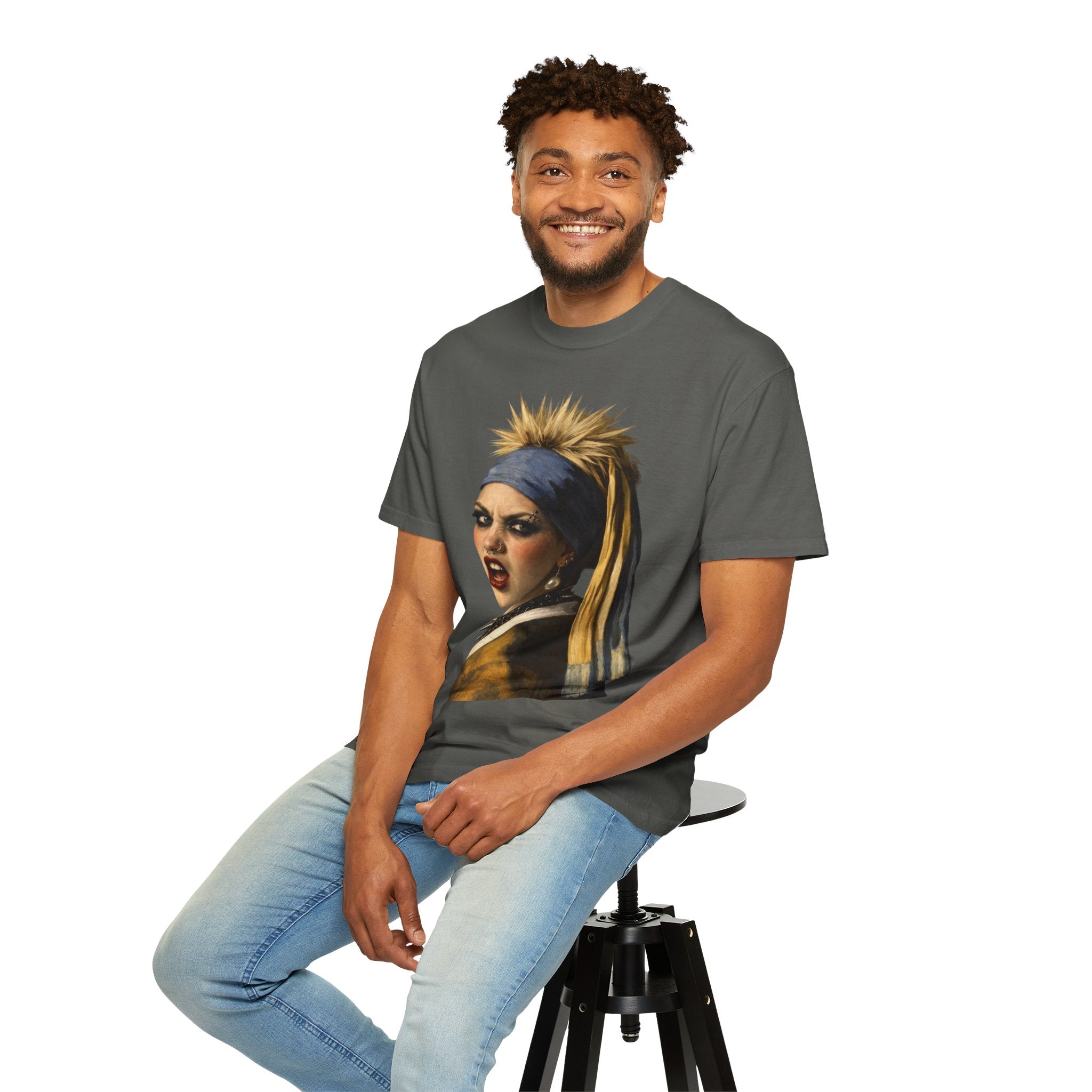Person wearing a grey t-shirt with a reimagined image of Vermeer's girl with a pearl earring sitting on a stool against a white background