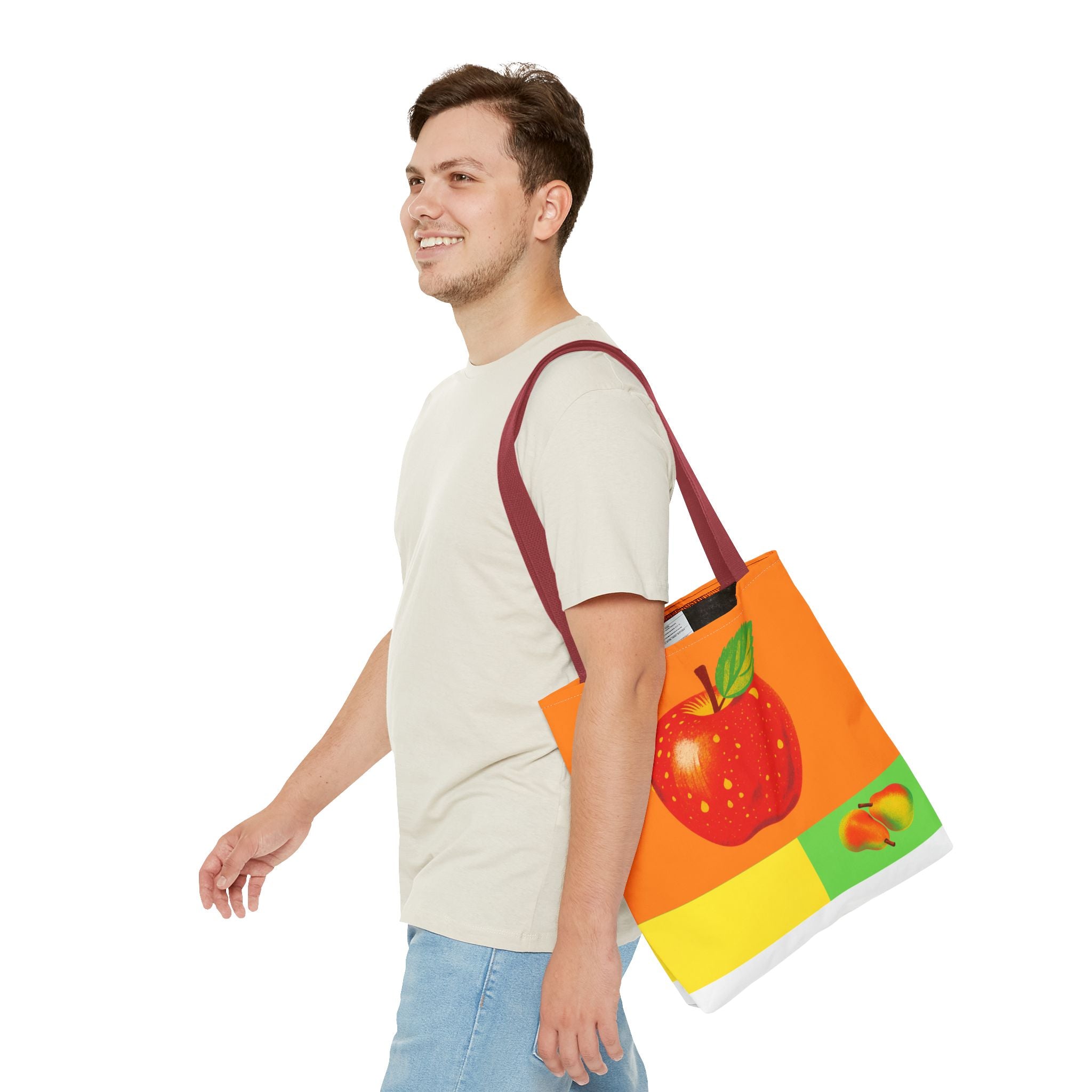 Man carrying a colorful tote bag with fruit design on a white background