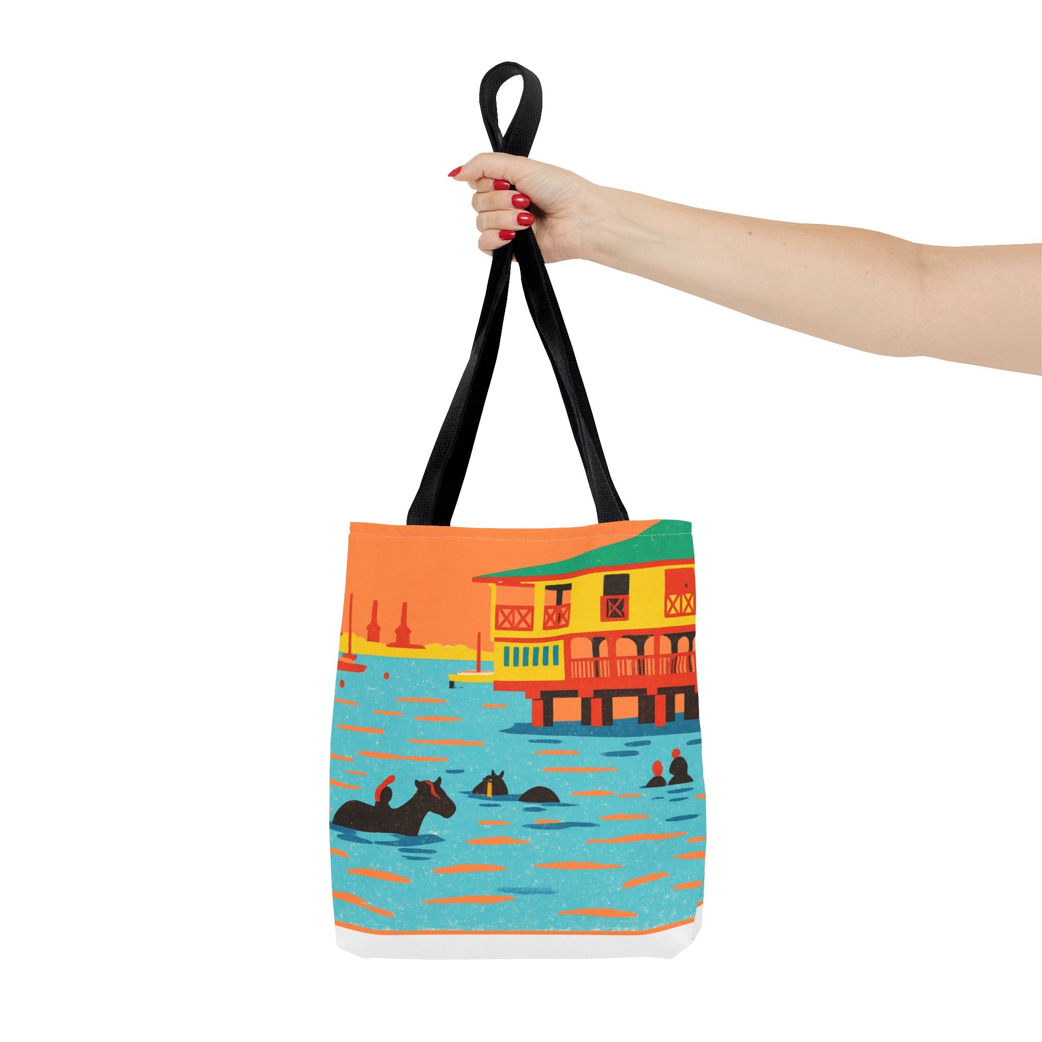 Woman holding a colourful tote bag showing horses swimming at Pebbles Beach, Barbados