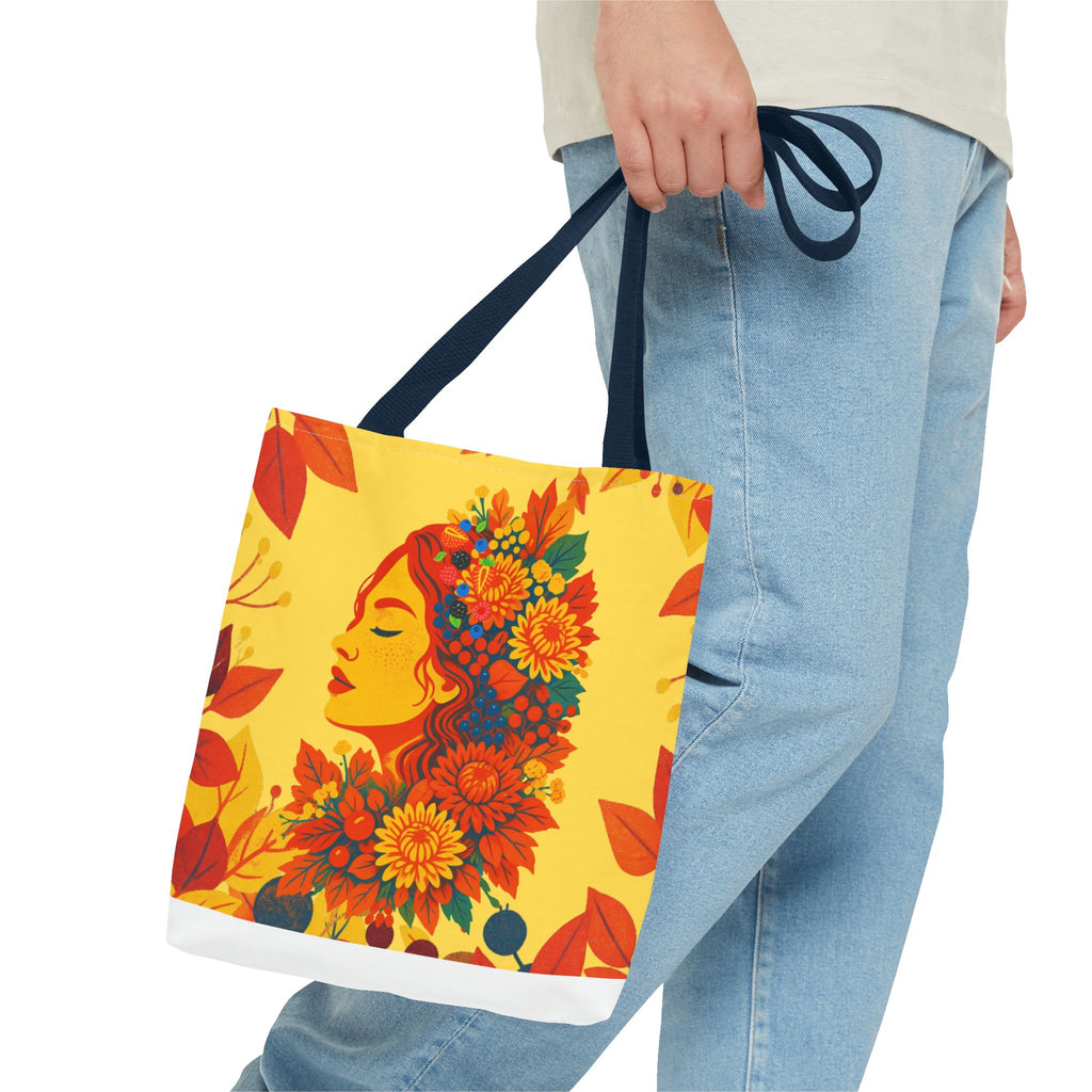 Tote bag with floral face design held by a person wearing jeans