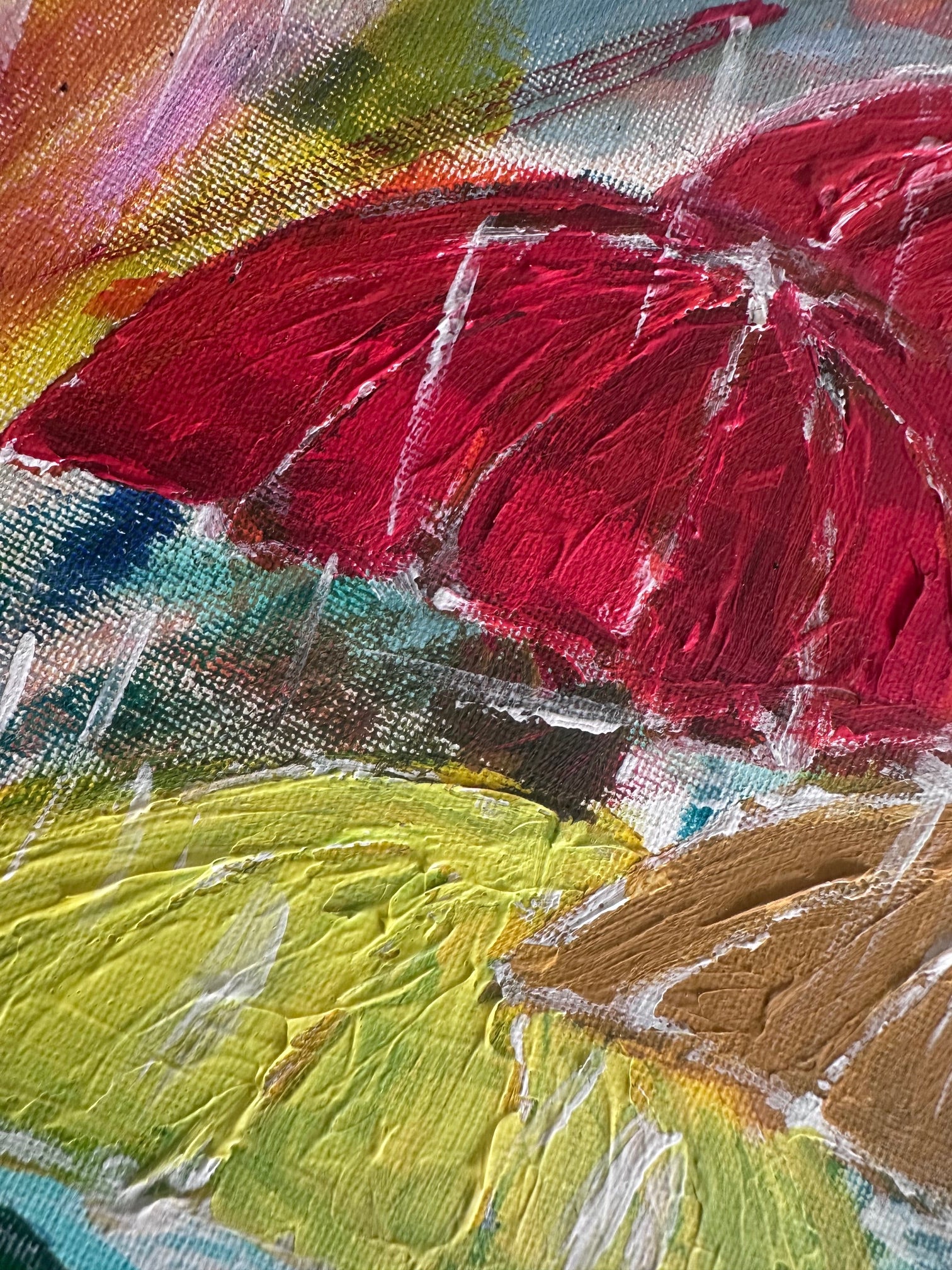 Close-up of a colorful abstract painting with red, yellow, and brown umbrellas.